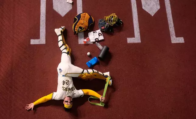 Milwaukee Brewers' William Contreras warms up before Game 2 of baseball's National League Championship Series against the Los Angeles Dodgers Tuesday, Oct. 14, 2025, in Milwaukee. (AP Photo/Morry Gash)
