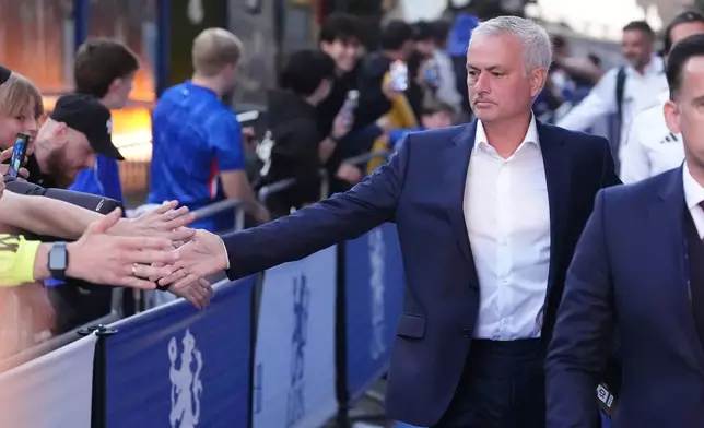 Benfica'a head coach Jose Mourinho walks to the stadium ahead of the Champions League opening phase soccer match between Chelsea and Benfica at Stamford Bridge, London, Tuesday Sept. 30, 2025. (Bradley Collyer/PA via AP)