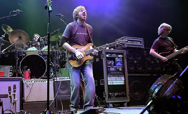 FILE - The group Phish, drummer Jon Fishman, guitarist Trey Anastasio, center, and bassist Mike Gordon, perform in this Dec. 31, 2002 file photo at New York's Madison Square Garden. (AP Photo/Stephen Chernin, File)