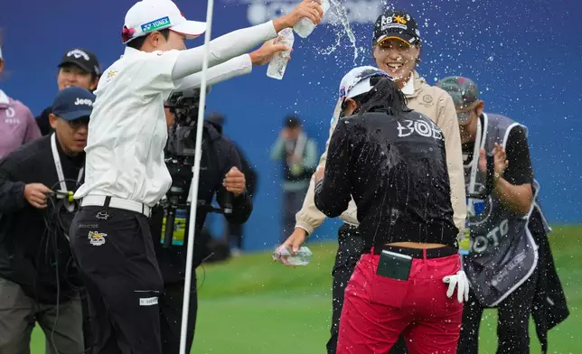 Sei Young Kim of South Korea, right, celebrates after winning the LPGA Ladies Championship golf tournament at the Pine Beach Golf Links, in Haenam, South Korea, Sunday, Oct. 19, 2025. (AP Photo/Lee Jin-man)