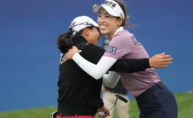 Sei Young Kim of South Korea, left, is greeted by Yealimi Noh of the United States after Kim won the LPGA Ladies Championship golf tournament at the Pine Beach Golf Links, in Haenam, South Korea, Sunday, Oct. 19, 2025. (AP Photo/Lee Jin-man)