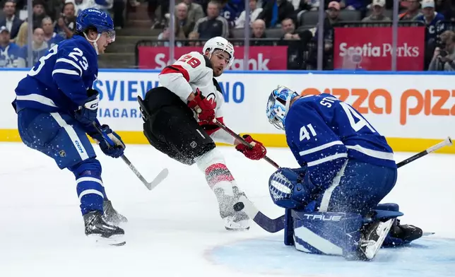 Toronto Maple Leafs goaltender Anthony Stolarz (41) makes a save on New Jersey Devils right wing Timo Meier (28) during the third period of an NHL hockey game in Toronto, Tuesday, Oct. 21, 2025. (Nathan Denette/The Canadian Press via AP)