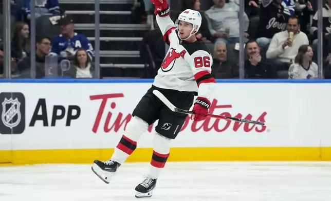 New Jersey Devils centre Jack Hughes (86) celebrates his goal during second period NHL hockey action against the Toronto Maple Leafs, in Toronto, Tuesday, Oct. 21, 2025. (Nathan Denette/The Canadian Press via AP)