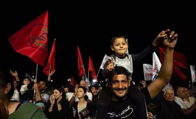 Supporters of the newly elected leader Tufan Erhurman celebrate after winning the leadership election in the Turkish occupied northern part of the divided capital Nicosia, Cyprus, Sunday, Oct. 19, 2025. (AP Photo/Nedim Enginsoy)
