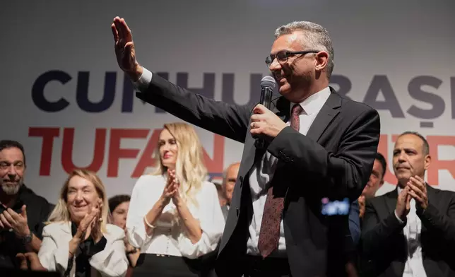 Turkish Cypriot newly elected leader Tufan Erhurman waves to supporters after winning the leadership election in the Turkish occupied northern part of the divided capital Nicosia, Cyprus, Sunday, Oct. 19, 2025. (AP Photo/Nedim Enginsoy)