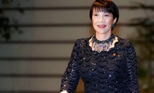 FILE - Sanae Takaichi, newly appointed Internal Affairs and Communications minister, enters the prime minister's official residence in Tokyo, Sept. 11, 2019. (AP Photo/Eugene Hoshiko, File)