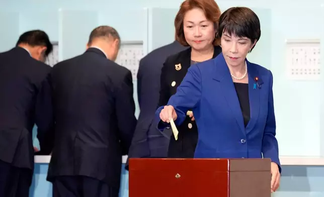 FILE - Candidate Sanae Takaichi, right, casts her ballot at the Liberal Democratic Party's (LDP) leadership election at the party headquarters, Sept. 27, 2024, in Tokyo. (AP Photo/Hiro Komae, Pool, File)