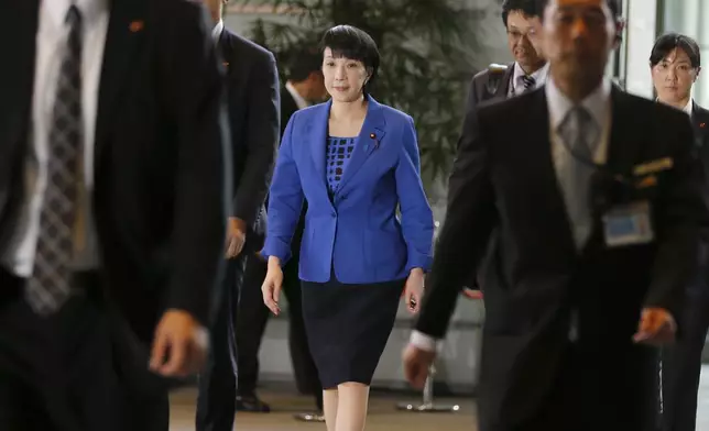 FILE - Japan's Internal Affairs Minister Sanae Takaichi, center, arrives at the prime minister's official residence in Tokyo, Aug. 3, 2016. (AP Photo/Shizuo Kambayashi, File)