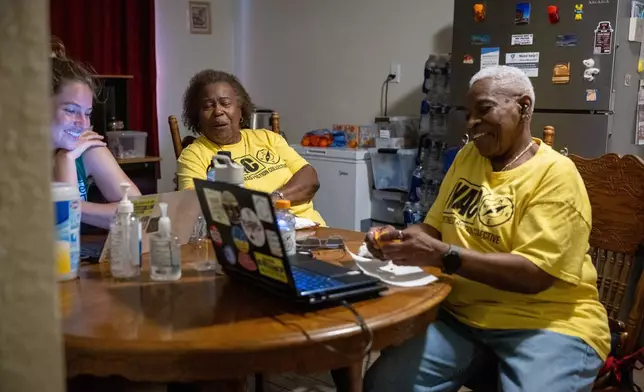 From left, Becky Selle, Leola Cornett-Traeye and Doris Brown sit at Brown's dinning table on Wednesday, Oct. 8, 2025, in Houston. (AP Photo/Antranik Tavitian)