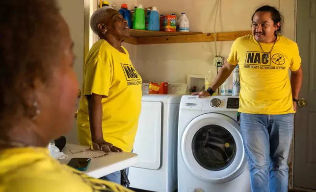 From left, Leola Cornett-Traeye, Doris Brown, Hub home captain, and David Espinoza, Hub home captain and co-director of community organizing at West Street Recovery, talk inside Brown's hub home, Wednesday, Oct. 8, 2025, in Houston. (AP Photo/Antranik Tavitian)