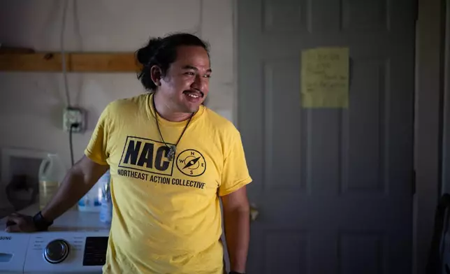 David Espinoza, Hub home captain and co-director of community organizing at West Street Recovery, smiles inside of fellow hub home captain Doris Brown's home, Wednesday, Oct. 8, 2025, in Houston. (AP Photo/Antranik Tavitian)