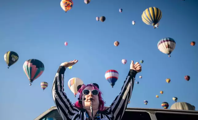 FILE - Launch Director Kat Brennan signals for a pilot to go ahead and take off Oct. 7, 2023, during the Albuquerque International Balloon Fiesta in Albuquerque, N.M. (AP Photo/Roberto E. Rosales, File)