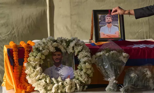 A Nepalese man pays his respects to Bipin Joshi, a Nepali man who was taken hostage by Hamas, during a memorial procession at Tribhuvan International Airport in Kathmandu, Nepal, Monday, Oct. 20, 2025. (AP Photo/Niranjan Shrestha)