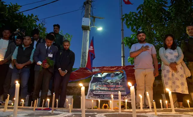 People participate in a candlelight vigil for Bipin Joshi, a Nepali man who was taken hostage by Hamas on Oct. 7, 2023, and was recently declared dead, in Kathmandu, Nepal, Wednesday, Oct. 15, 2025. (AP Photo/Niranjan Shrestha)