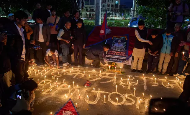People participate in a candlelight vigil for Bipin Joshi, a Nepali man who was taken hostage by Hamas on Oct. 7, 2023, and was recently declared dead, in Kathmandu, Nepal, Wednesday, Oct. 15, 2025. (AP Photo/Niranjan Shrestha)