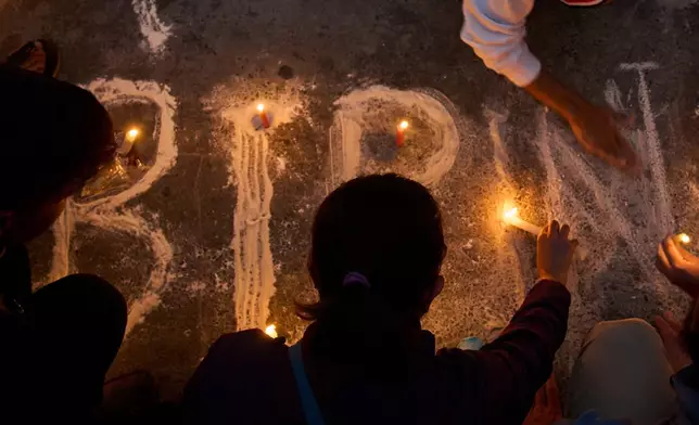 People participate in a candlelight vigil for Bipin Joshi, a Nepali man who was taken hostage by Hamas on Oct. 7, 2023, and was recently declared dead, in Kathmandu, Nepal, Wednesday, Oct. 15, 2025. (AP Photo/Niranjan Shrestha)