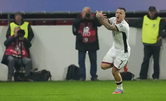 Albania's Rey Manaj celebrates after scoring his side's opening goal during the World Cup Group K qualifying soccer match between Serbia and Albania, at the Dubocica Stadium in Leskovac, Serbia, Saturday, Oct. 11, 2025. (AP Photo/Darko Vojinovic)
