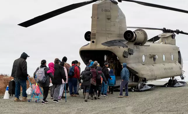 In this photo provided by the Alaska Army National Guard, displaced people are evacuated from Kwigillingok, Alaska, on Thursday, Oct. 16, 2025, following Typhoon Halong that struck Alaska's west coast. (Joseph Moon/Alaska National Guard via AP)