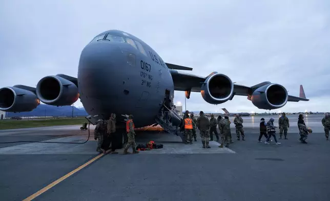 In this photo provided by the Alaska National Guard, an Alaska Air National Guard C-17 Globemaster III, assigned to the 176th Wing, arrives at Joint Base Elmendorf-Richardson, Alaska, with evacuated residents from western Alaska, Wednesday, Oct. 15, 2025. (Alejandro Pena/Alaska National Guard via AP)