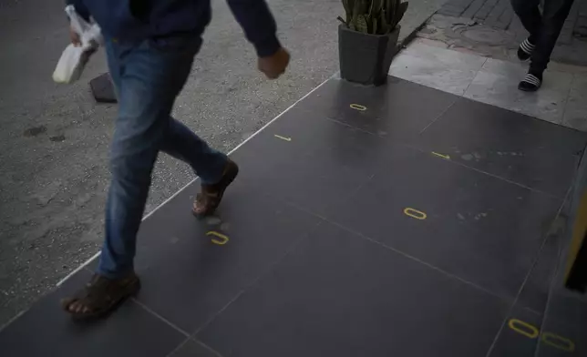 People walk past the spot where 10-year-old Saddam Rajab was shot by an Israeli soldier in the West Bank city of Tulkarem, March 17, 2025. (AP Photo/Leo Correa)