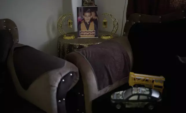 A photo of 12-year-old Ayman al-Heimouni, who was killed by Israeli gunfire, is displayed among Ramadan decorations in a room of his family's home in the West Bank city of Hebron, March 26, 2025. (AP Photo/Leo Correa)