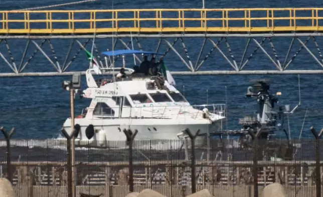Israeli navy soldiers sail one of the Gaza-bound civilian flotilla Sumud's boats into the port of Ashdod, Israel, Thursday, Oct. 2, 2025, after it was intercepted off the Gaza coast. (AP Photo/Leo Correa)