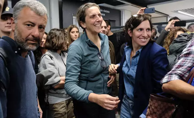 Italian Democratic party leader Elly Schlein, right, welcomes members of Italian Parliament Arturo Scotto, left, and Annalisa Corrado upon their landing at the Rome Leonardo da Vinci airport after being released by Israeli authorities following their detention for being aboard boats of the Global Sumud Flottila. (Mauro Scrobogna/LaPresse via AP)