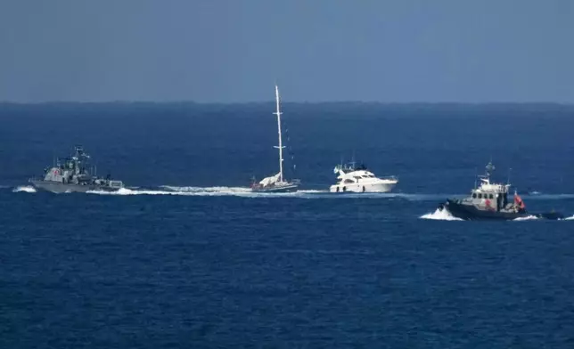 An Israeli Navy vessel sails next to two smaler boats in the Mediterranean sea close to the port of Ashdod, Israel, Thursday, Oct. 2, 2025. (AP Photo/Leo Correa)
