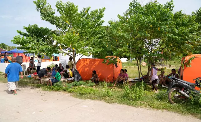Survivors of Tuesday's earthquake stay in open spaces on Thursday, Oct. 2, 2025 in San Remigio, Cebu Province, Central Philippines. (AP Photo/Aaron Favila)