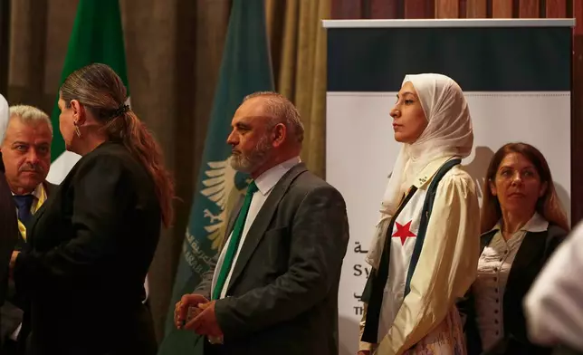 Syrian electoral college members line up to cast their ballots in a parliamentary election at a polling station in Damascus, Syria, Sunday, Oct. 5, 2025. (AP Photo/Omar Sanadiki)