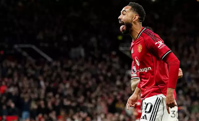 Manchester United's Matheus Cunha celebrates scoring the opening goal during the English Premier League soccer match between Manchester United and Brighton &amp; Hove Albion in Manchester, England, Saturday, Oct. 25, 2025. (Martin Rickett/PA via AP)