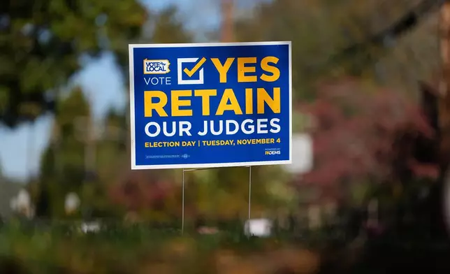 A sign is posted in support of retaining Pennsylvania Supreme Court justices in the November election, in Berwyn, Pa., Wednesday, Oct. 22, 2025. (AP Photo/Matt Rourke)