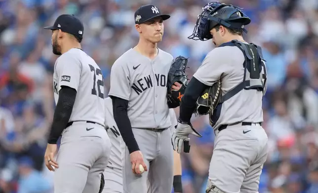 New York Yankees pitcher Luke Weaver, center, waits to be removed during the seventh inning against the Toronto Blue Jays in Game 1 of baseball's American League Division Series, Saturday, Oct. 4, 2025, in Toronto. (Nathan Denette/The Canadian Press via AP)