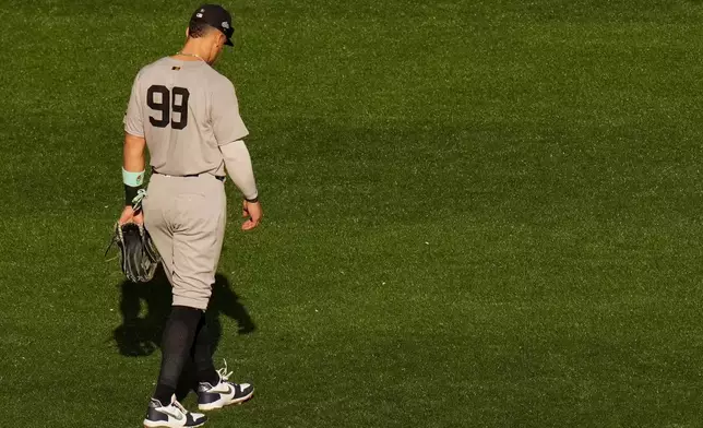 New York Yankees right fielder Aaron Judge (99) looks on during a break in play during the second inning in Game 1 of baseball's American League Division Series against the Toronto Blue Jays, Saturday, Oct. 4, 2025, in Toronto. (Chris Young/The Canadian Press via AP)