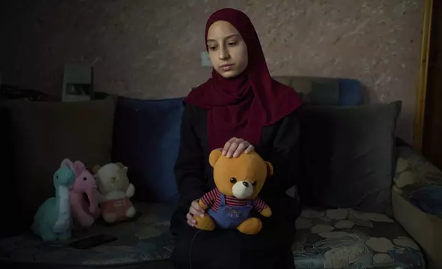 Tayma Asous, 26, holds the favorite toy of her 2-year-old daughter, Layla Al-Khatib, who was killed after being shot in the head by Israeli gunfire, at their home in the village of Muthallath ash-Shuhada, near the West Bank city of Jenin, March 11, 2025. (AP Photo/Leo Correa)