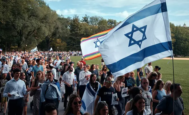 Jews march around the Great Lawn in Manhattan's Central Park for a "Circle of Unity" event marking the second anniversary of the deadly Oct. 7 attack in Israel, on Tuesday, Oct. 7, 2025, in New York. (AP Photo/Andres Kudacki)