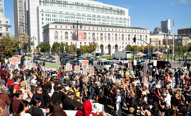Protesters against U.S. Immigration and Customs Enforcement rally outside city hall on Thursday, Oct. 23, 2025, in San Francisco. (AP Photo/Noah Berger)