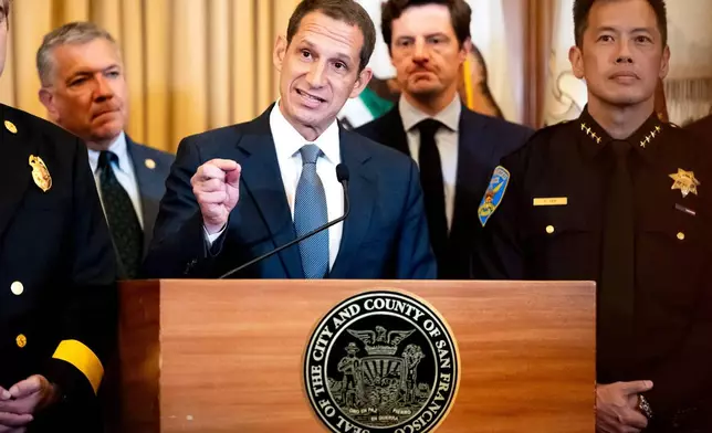 Flanked by city leaders, San Francisco Mayor Daniel Lurie discusses President Donald Trump's comments that he has called off a surge of federal law enforcement in San Francisco on Thursday, Oct. 23, 2025, in San Francisco. (AP Photo/Noah Berger)