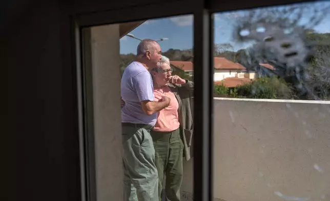FILE - Pete and Gillian Brisley visit the home of their daughter, who was killed along with her two daughters in Hamas' Oct. 7 attack, and their son-in-law, Eli Sharabi, who was taken captive, in Kibbutz Be'eri, southern Israel, Wednesday, Feb. 21, 2024. (AP Photo/Ohad Zwigenberg, File)