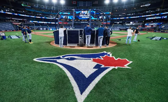The Seattle Mariners gather around the cage during batting practice, Saturday, Oct. 18, 2025, in Toronto, ahead of Sunday's Game 6 in baseball's American League Championship Series against the Toronto Blue Jays. (Sammy Kogan/The Canadian Press via AP)