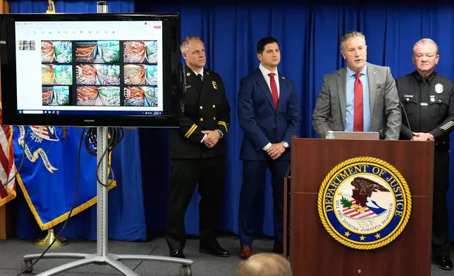 Special Agent in Charge Kenny Cooper, of the Bureau of Alcohol, Tobacco, Firearms and Explosives, Los Angeles Field Division, second from right, speaks between Acting U.S. Attorney Bill Essayli, second from left, and Los Angeles Police Chief Jim McDonnell, right, during a news conference announcing an arrest made in the Palisades Fire, Wednesday, Oct. 8, 2025, in Los Angeles. (AP Photo/Damian Dovarganes)