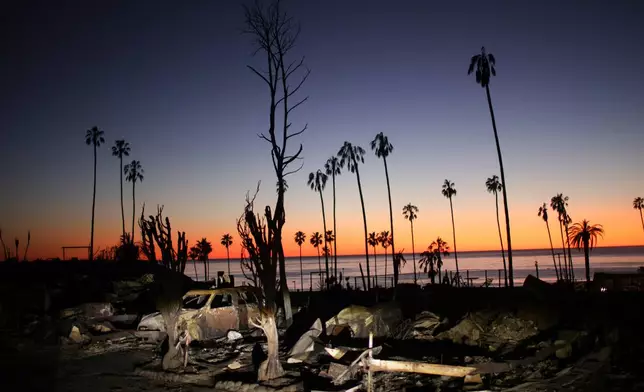 FILE - The devastation of the Palisades Fire is seen at sunset in the Pacific Palisades neighborhood of Los Angeles, Jan. 14, 2025. (AP Photo/Ethan Swope, file)