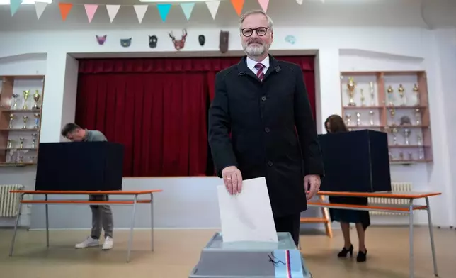 Czech Republic's Prime Minister and leader of coalition of three conservative parties called "Together" Petr Fiala casts his ballot at a polling station for a general election in Brno, Czech Republic, Friday, Oct. 3, 2025. (AP Photo/Darko Bandic)