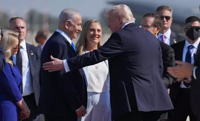 President Donald Trump greets Israel's Prime Minister Benjamin Netanyahu as he arrives at Ben Gurion International Airport, Monday, Oct. 13, 2025, near Tel Aviv. (AP Photo/Evan Vucci)