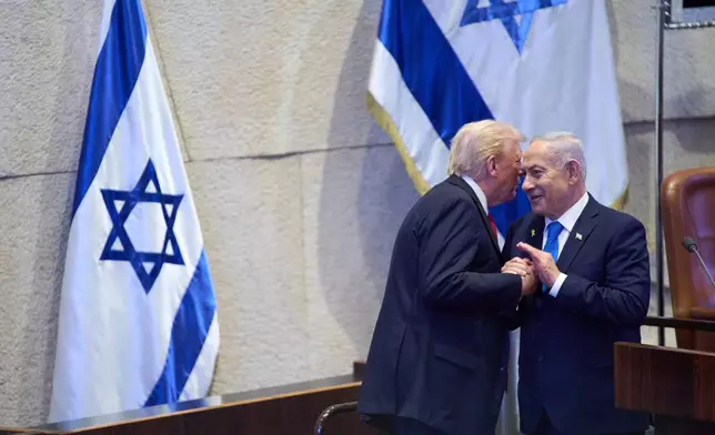 President Donald Trump talks with Israel's Prime Minister Benjamin Netanyahu at the Knesset, Israel's parliament, Monday, Oct. 13, 2025, in Jerusalem. (AP Photo/Evan Vucci, Pool)
