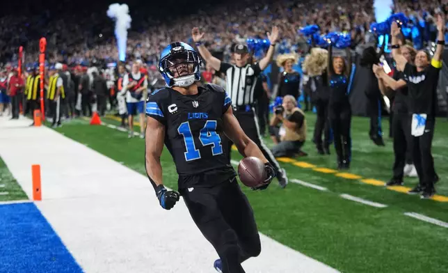 Detroit Lions wide receiver Amon-Ra St. Brown (14) celebrates his touchdown against the Tampa Bay Buccaneers during the first half of an NFL football game, Monday, Oct. 20, 2025, in Detroit. AP Photo/Paul Sancya)