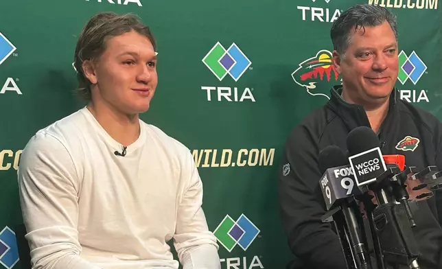 Minnesota Wild left wing Kirill Kaprizov and general manager Bill Guerin discuss Kaprizov's contract extension on Tuesday, Sept. 30, 2025, in St. Paul, Minn. (AP Photo/Dave Campbell)