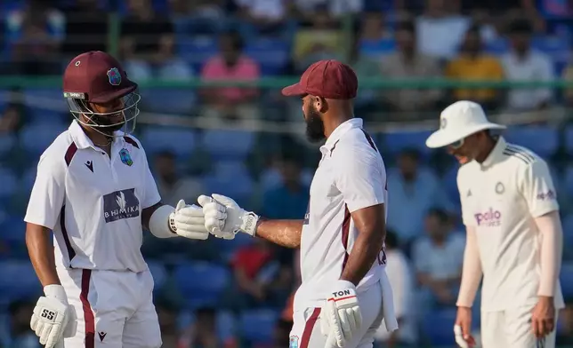 West Indies' John Campbell and Shai Hope give the fist touch after scoring runs on the third day of the second cricket test match between India and West Indies at the Arun Jaitley Stadium in New Delhi, India, Sunday, Oct.12, 2025. (AP Photo/Manish Swarup)