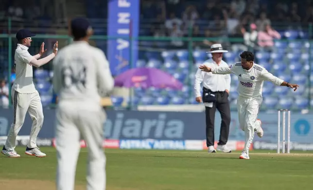 India's Kuldeep Yadav celebrates the dismissal of West Indies' Shai Hope on the third day of the second cricket test match between India and West Indies at the Arun Jaitley Stadium in New Delhi, India, Sunday, Oct.12, 2025. (AP Photo/Manish Swarup)