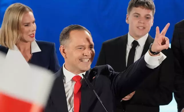 FILE - Presidential candidate Karol Nawrocki gestures at his headquarters after the presidential election runoff in Warsaw, Poland, on June 1, 2025. (AP Photo/Czarek Sokolowski, File)